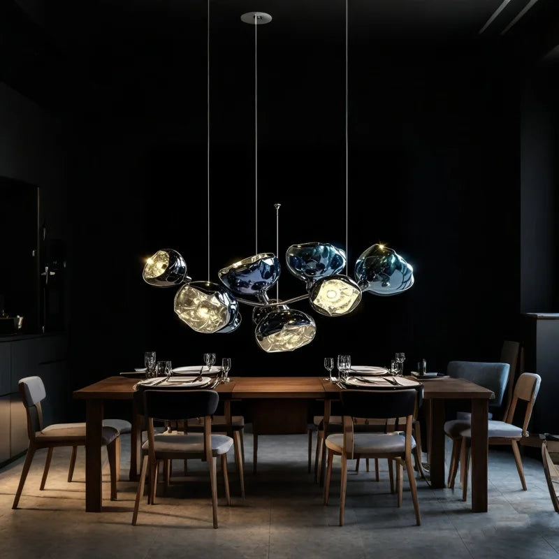 Nordic lava glass LED pendant light hanging in a modern living room interior with warm ambient lighting and contemporary home décor styling.