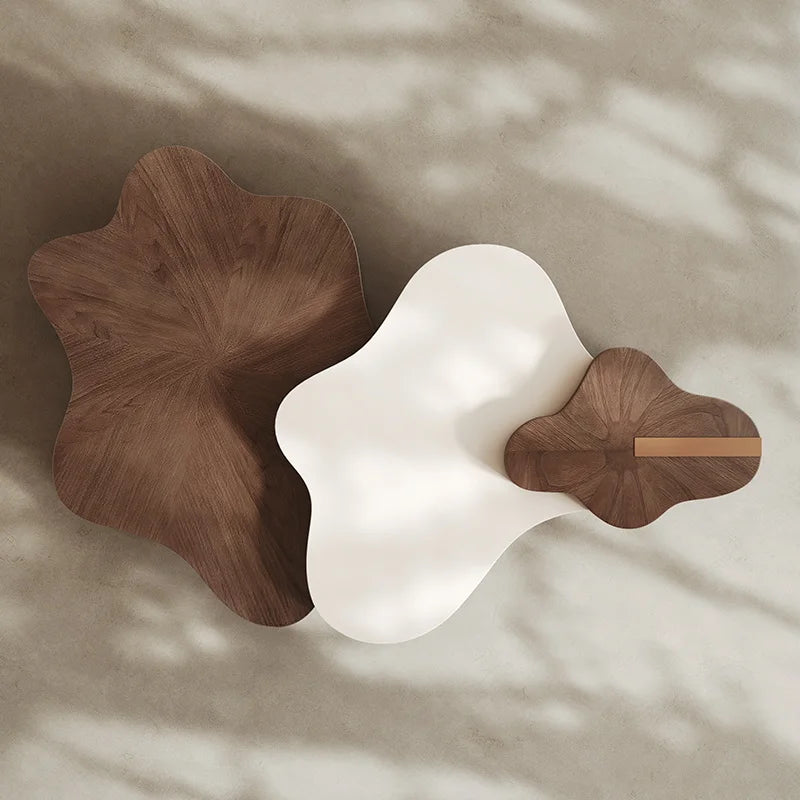 Two unique wooden stools with a white cushion on a neutral background