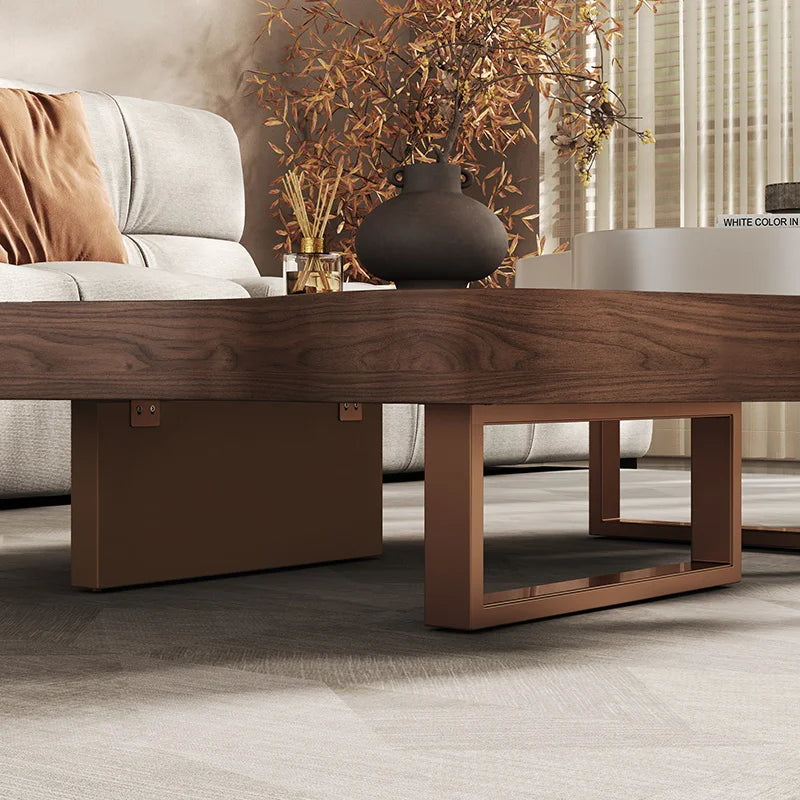 Wooden coffee table in a living room setting with a vase and decorative elements.