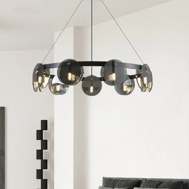 Modern Nordic black glass ring LED chandelier hanging in luxury living room interior with contemporary pendant lighting design