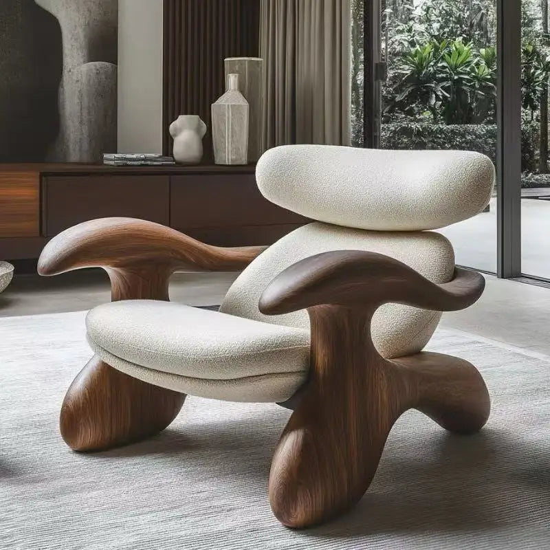 Modern chair with wooden legs and white cushioned seat in a room with large windows.