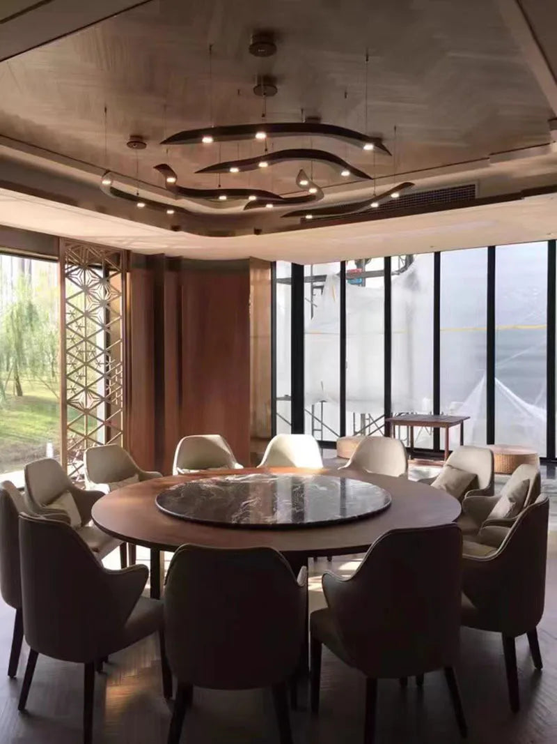 Modern dining room with round table and chairs near large windows