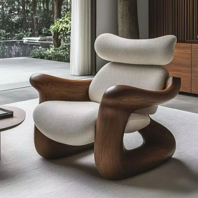 Modern chair with wooden armrests and beige cushion in a room with large windows.