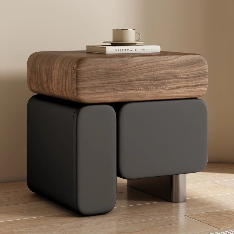 Wooden side table with a dark gray base on a wooden floor.