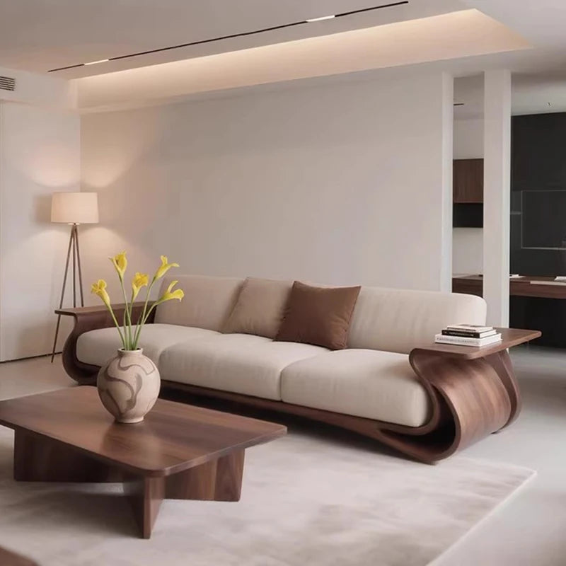 Modern living room with a beige sofa, wooden coffee table, and decorative elements.