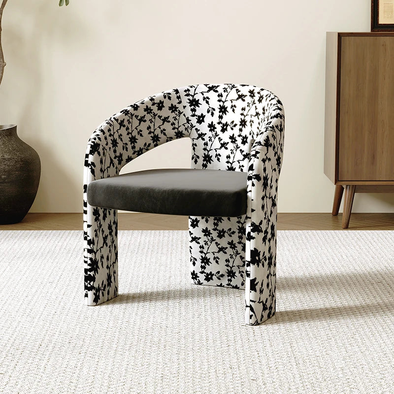 Chair with black floral pattern on a neutral background