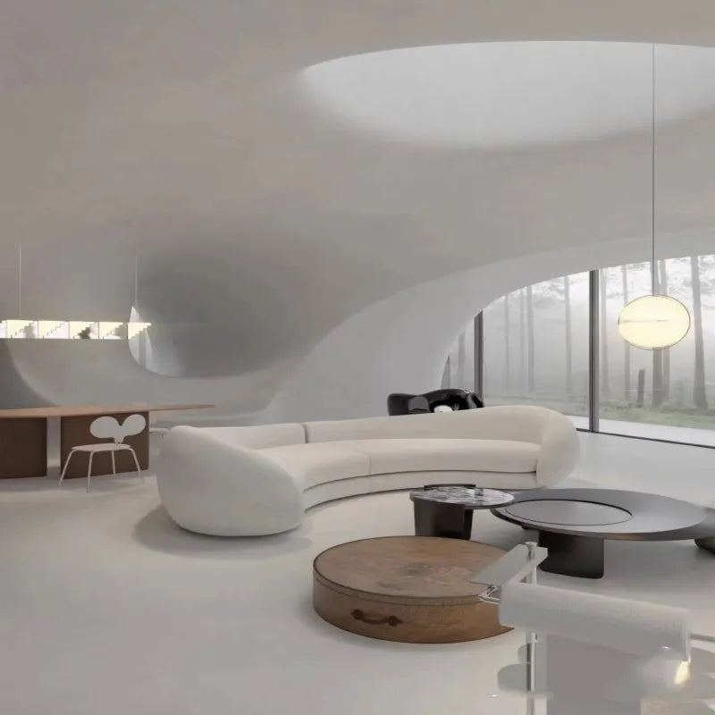 Modern living room with white curved sofa, wooden coffee table, and glass wall.