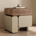 Wooden side table with a beige ottoman and a cup on a neutral background