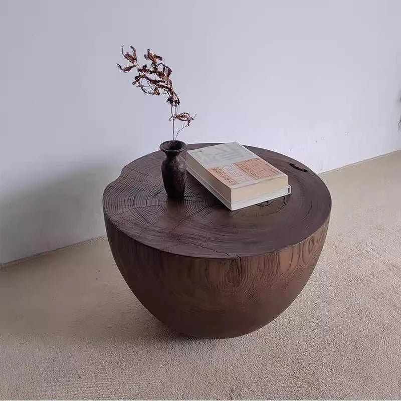 Wooden coffee table with decorative items on a plain background
