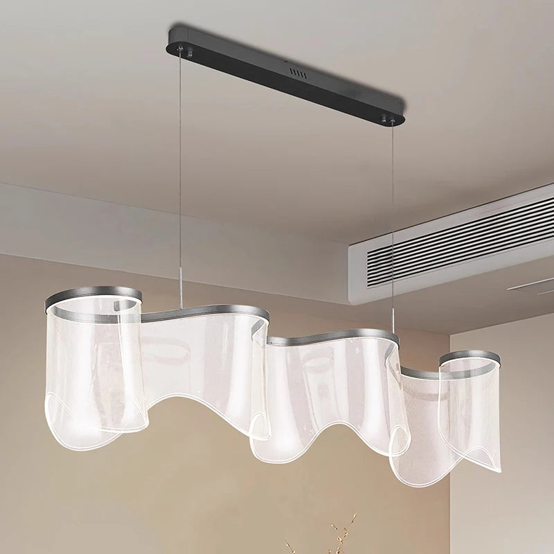 Modern pendant light fixture with wavy design in a room setting