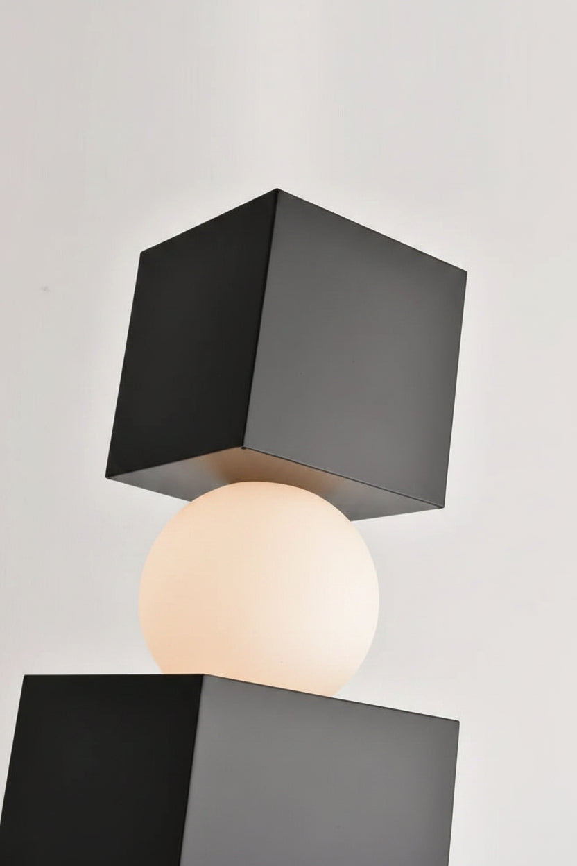 Black square lamp body with white sphere on a light gray background.