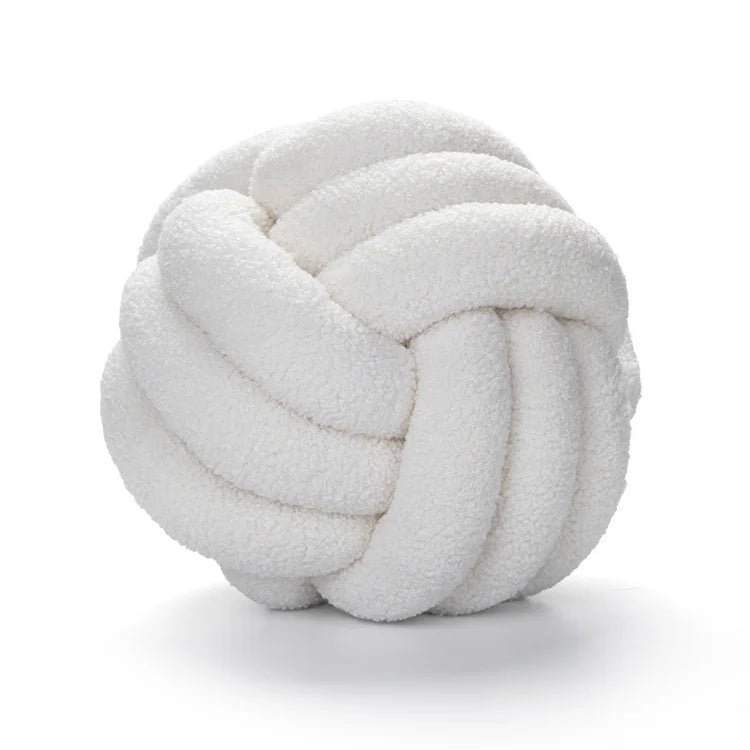 White knotted pillow on a white background