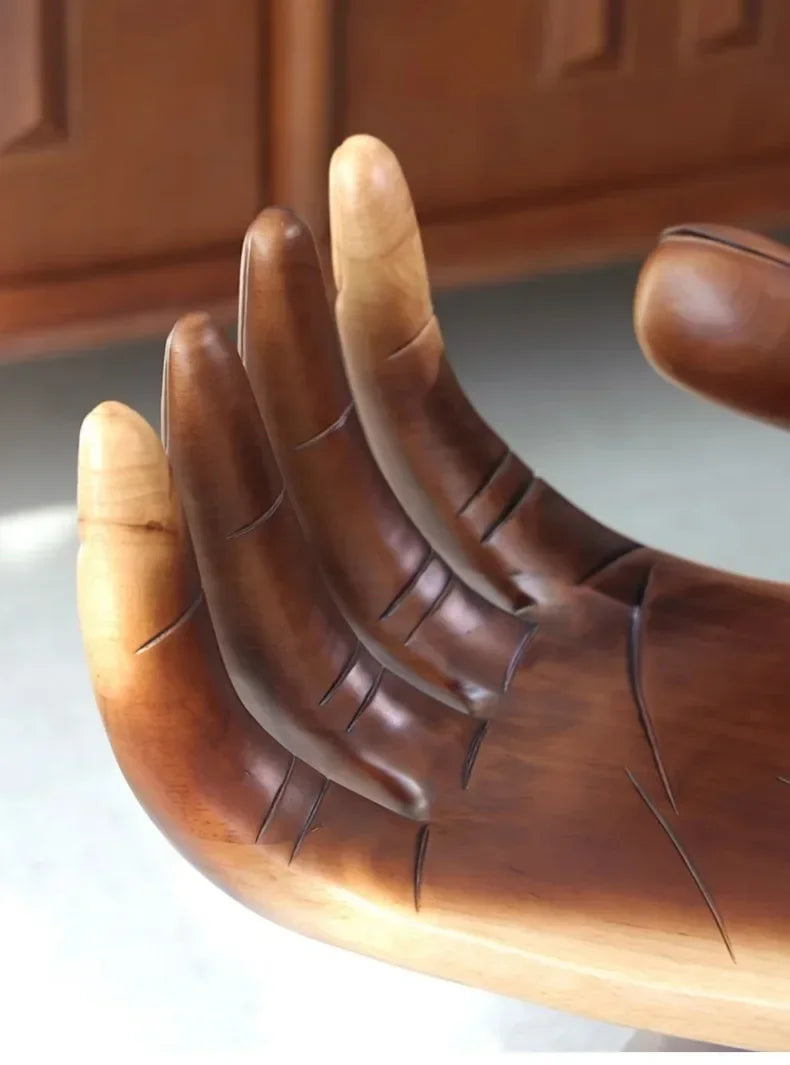 Brown leather glove with detailed stitching on a neutral background
