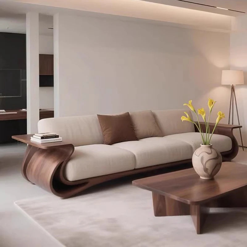 Modern living room with a curved beige sofa and wooden coffee table.