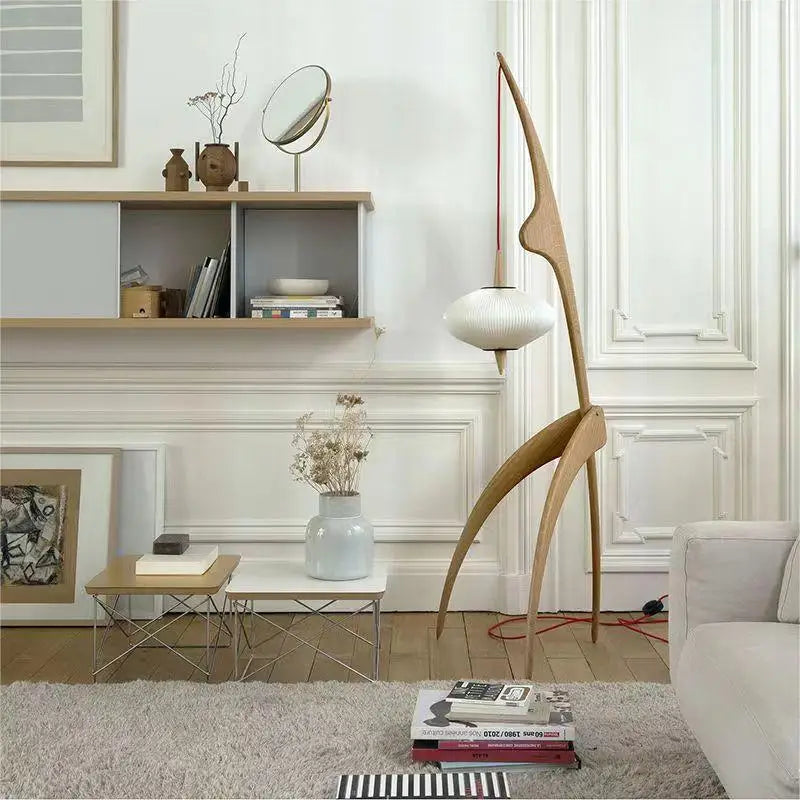 Modern living room with a floor lamp, coffee table, and decorative items.
