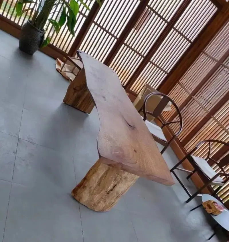 Wooden stool with a natural finish in a room with a tiled floor and wooden partition.