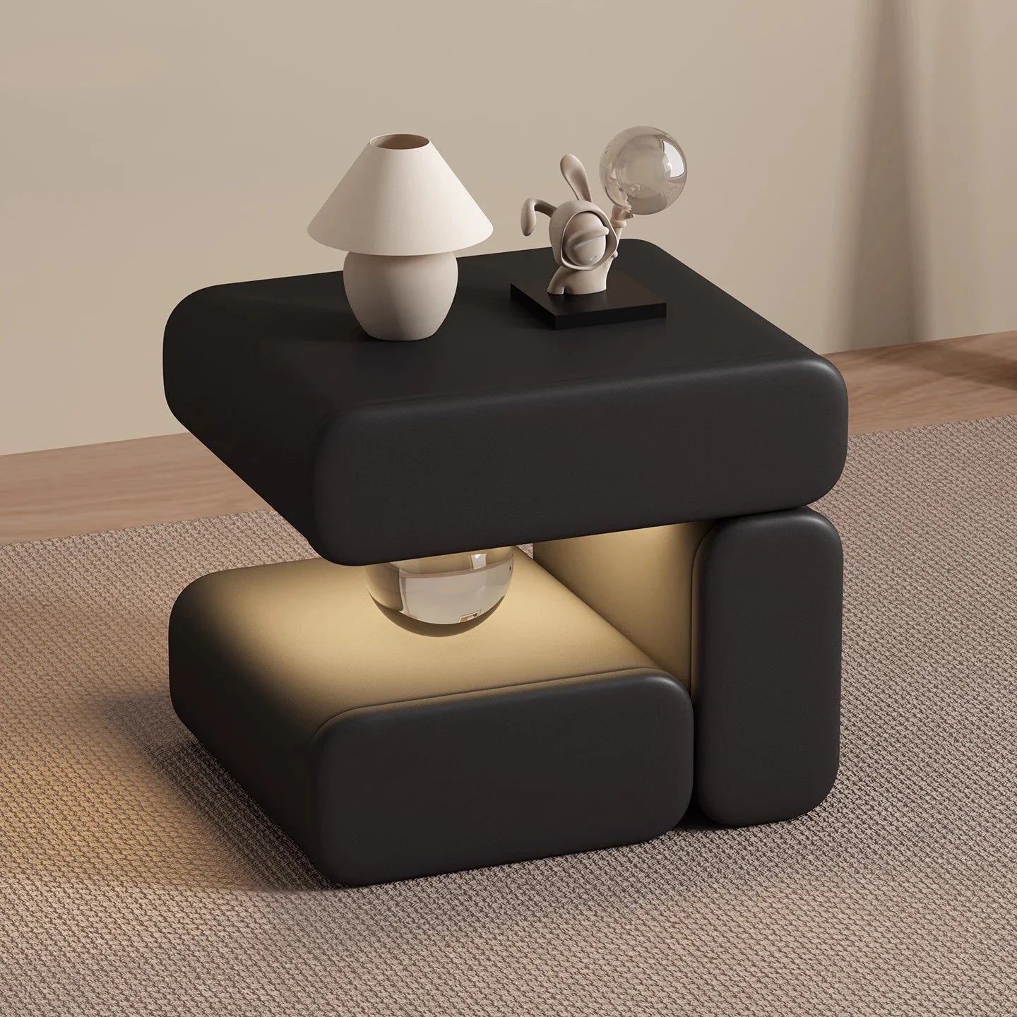 Modern black side table with decorative items on a neutral background