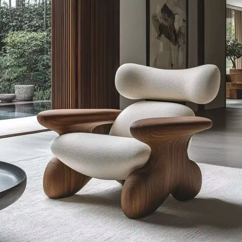 Modern chair with wooden legs and white cushioned seat and backrest in a room with a pool and garden view.