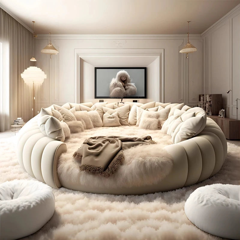 Modern living room with a large circular beige sofa and a TV displaying an image of a sheep.
