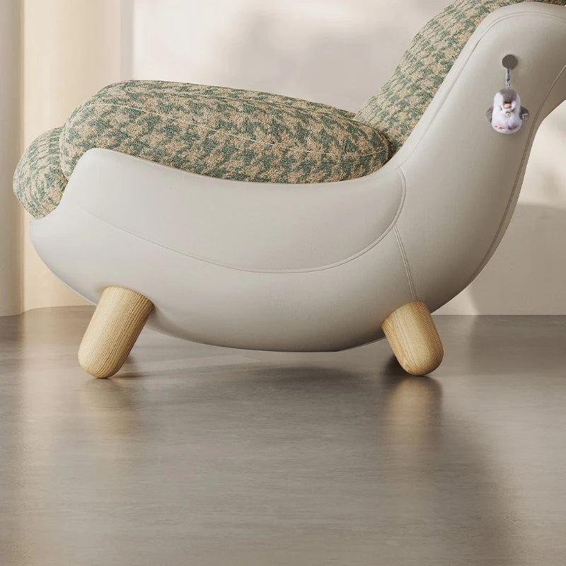 Children's chair with floral patterned cushion and wooden legs on a neutral background