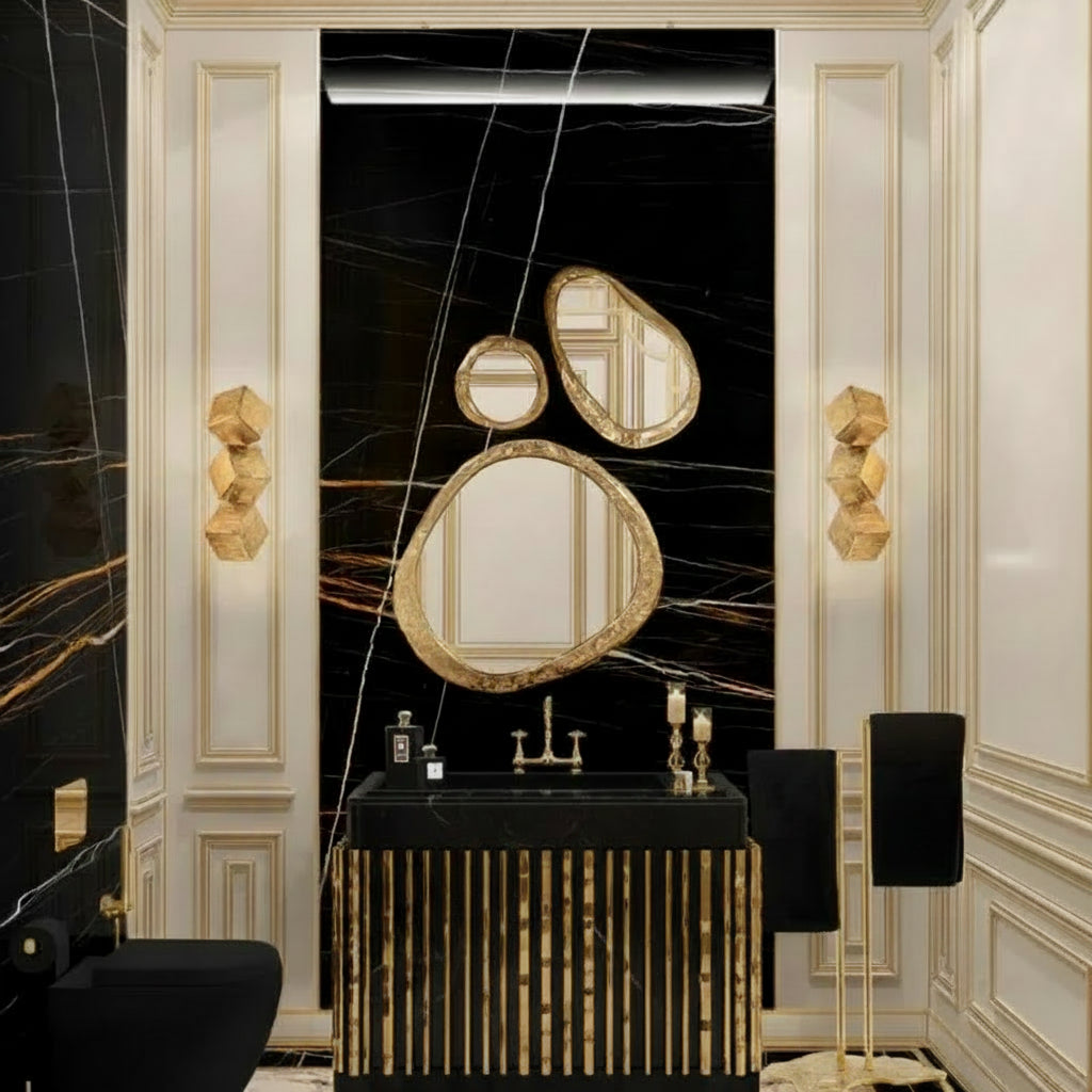 Luxurious bathroom interior with gold and black fixtures, mirrors, and wall sconces.
