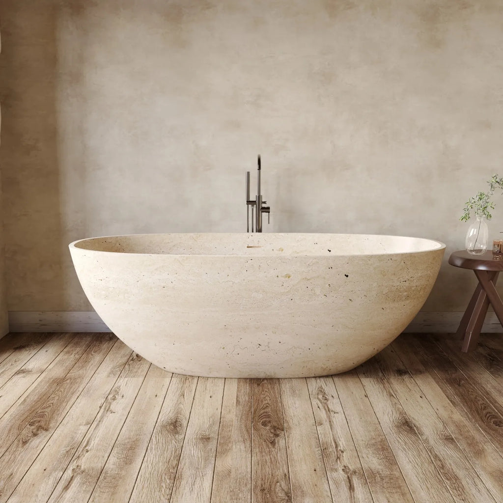 Beige freestanding bathtub in a bathroom with wooden floor and neutral walls