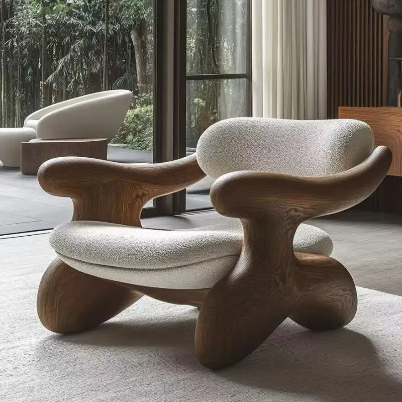Modern chair with wooden legs and white cushioned seat and backrest in a room with large windows.