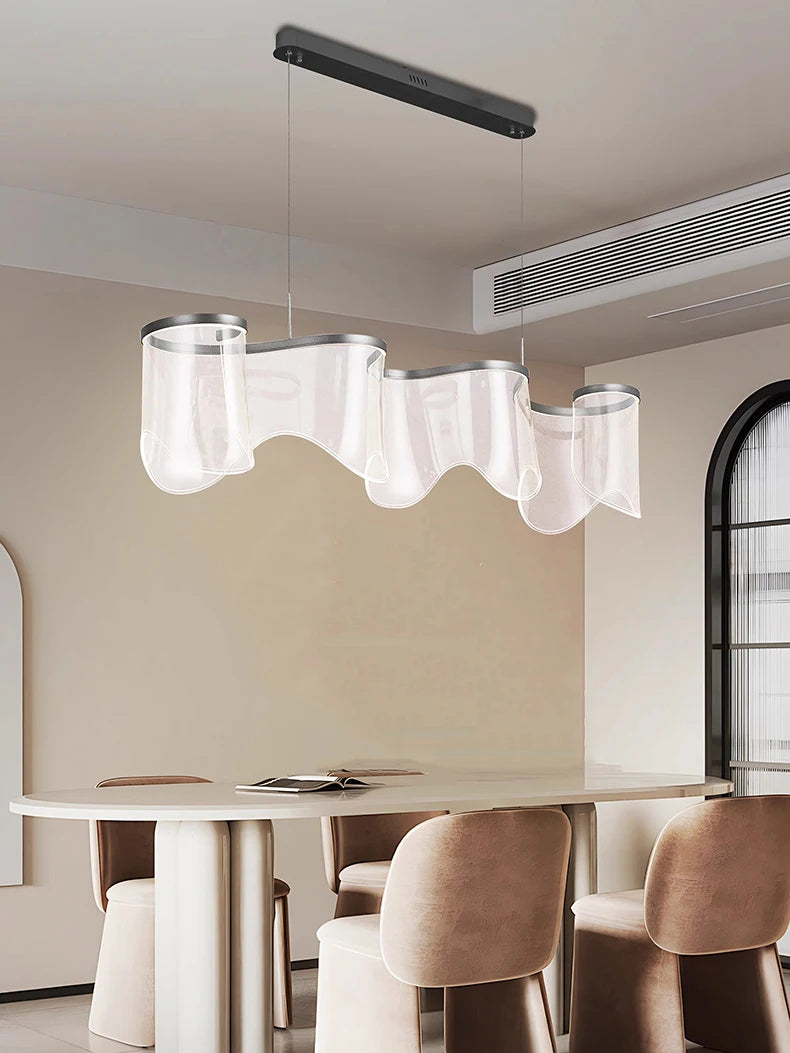Modern dining room with a unique ceiling light fixture.