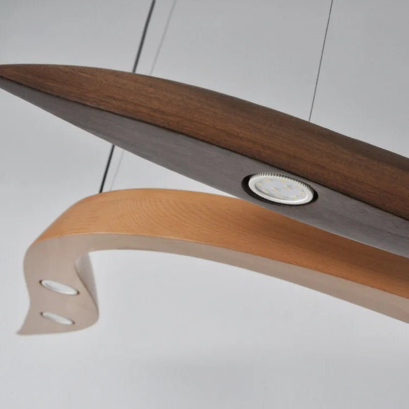 Wooden spoon with a metallic handle on a white background