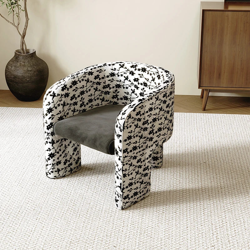Modern chair with black floral pattern on a light carpet