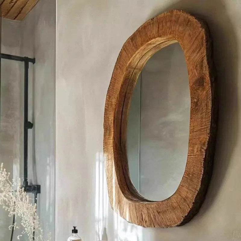Wooden-framed mirror on a wall with a neutral background