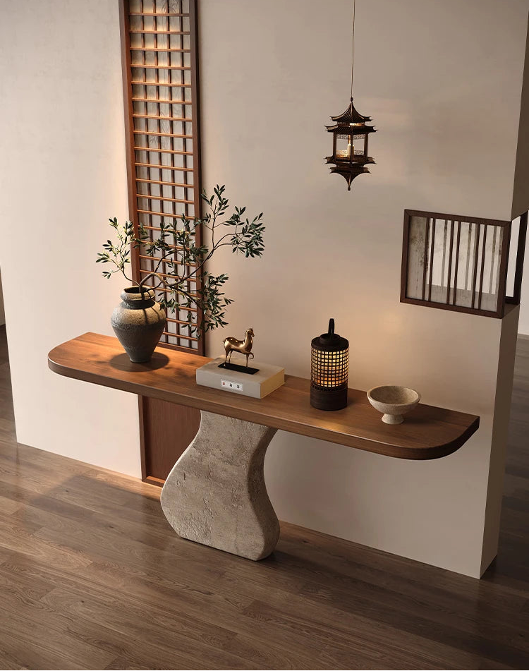 Wooden console table with decorative items in a room with wooden flooring and lattice wall.
