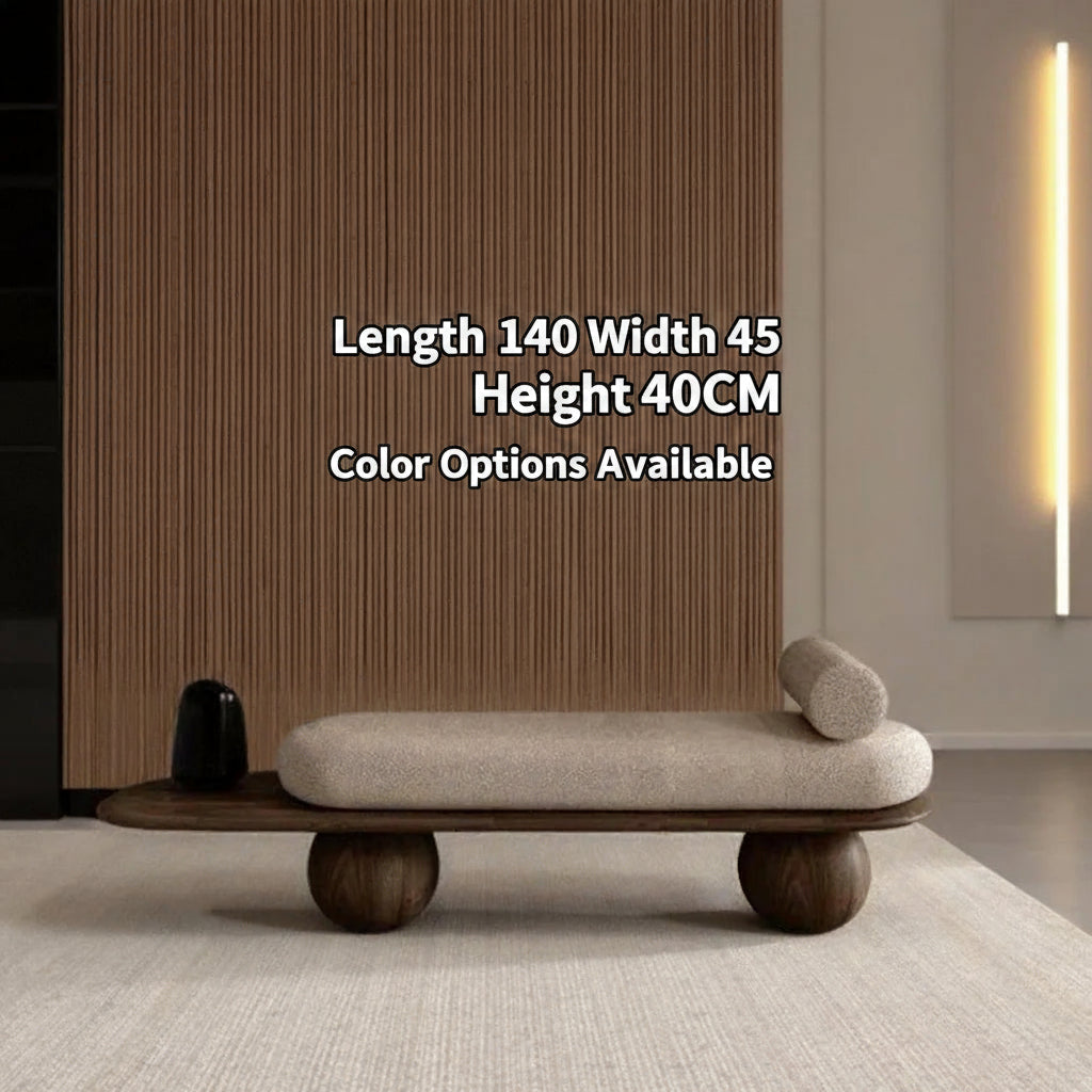 Modern bench with wooden legs and beige cushion in a minimalistic room.