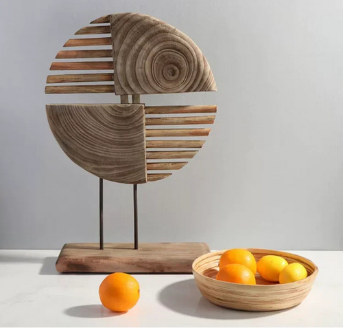 Wooden decorative piece with a bowl of oranges on a light background