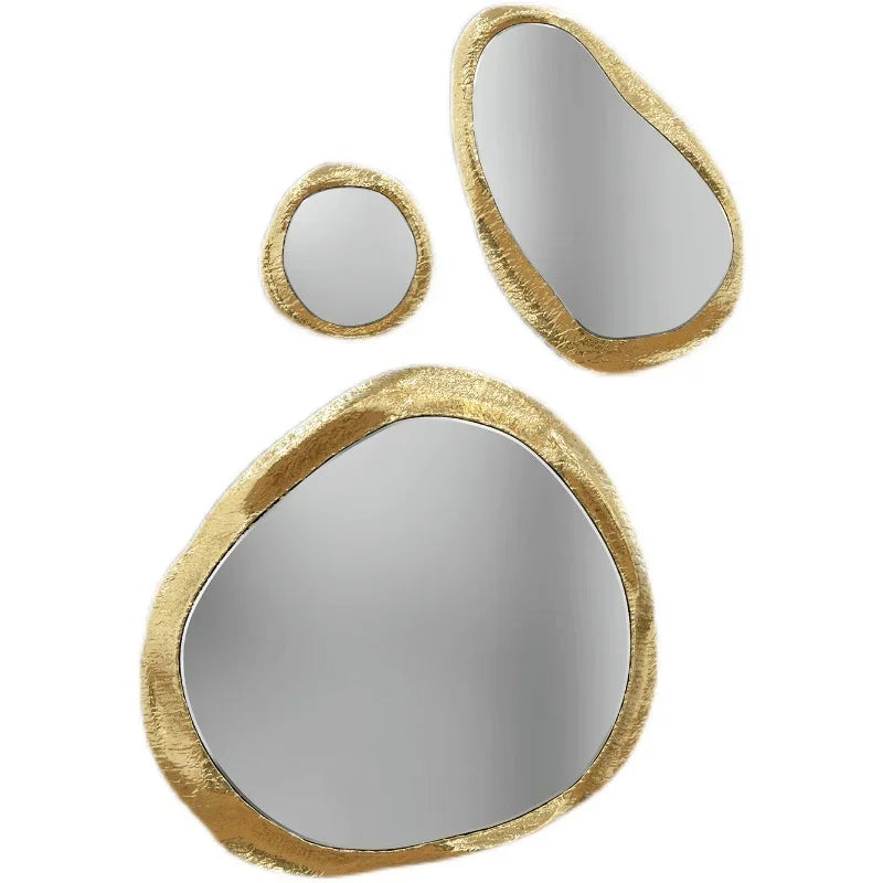 Three round mirrors with gold frames on a white background