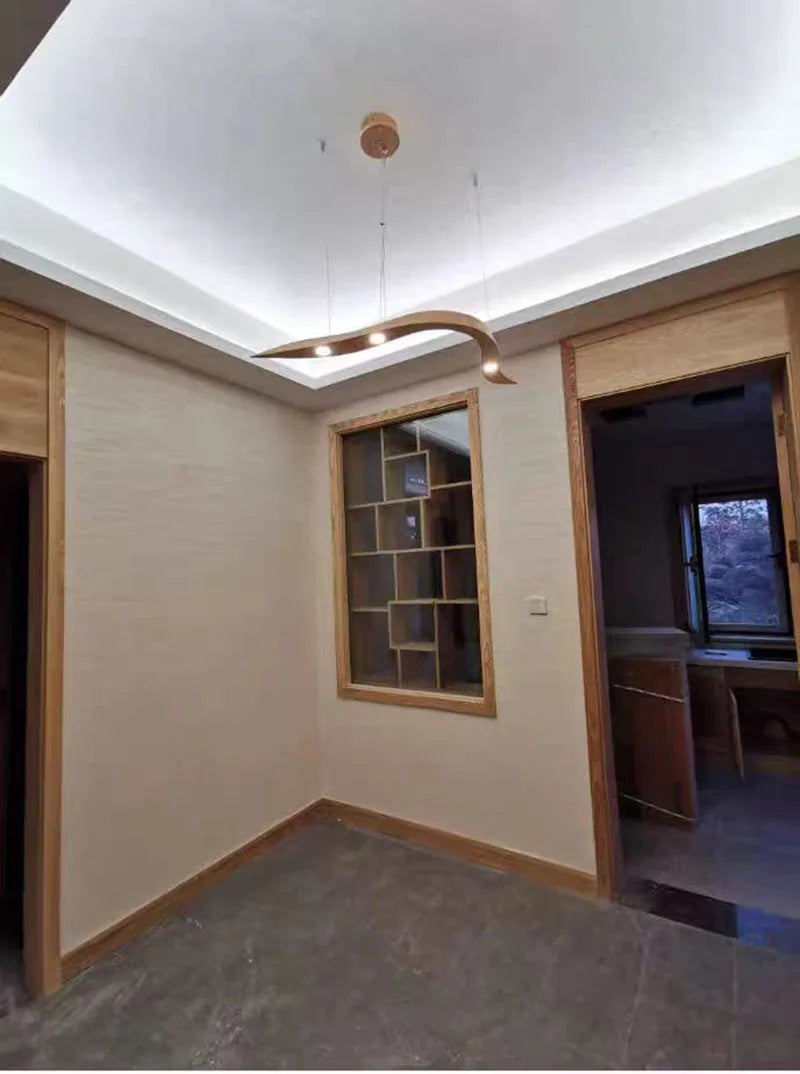 Empty room with wooden shelves and a ceiling light fixture