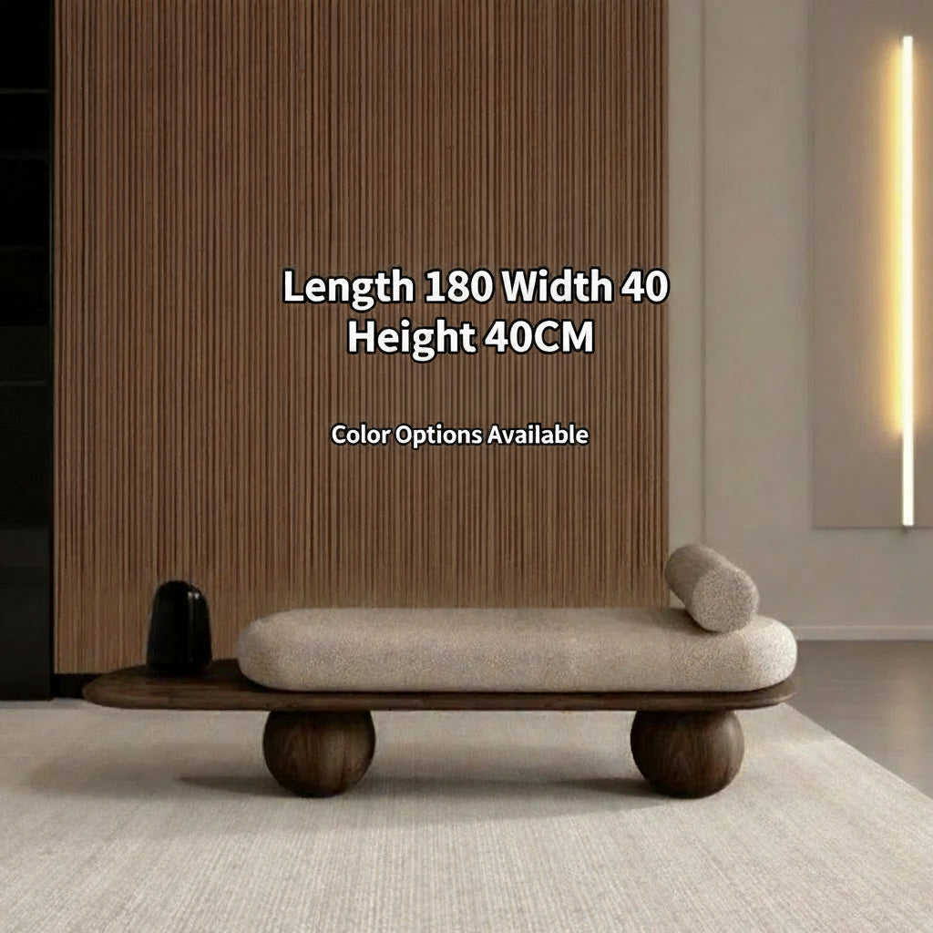 Modern bench with wooden legs and beige cushion in a minimalistic room.