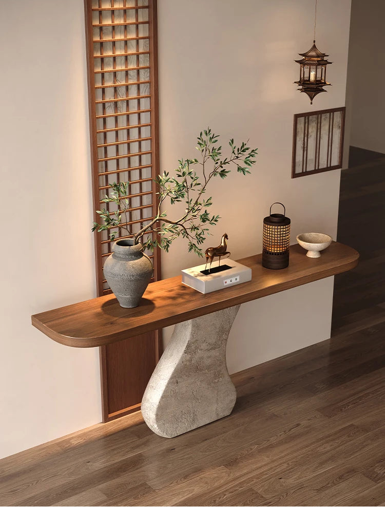 Wooden console table with decorative items in a room with wooden flooring and lattice wall.