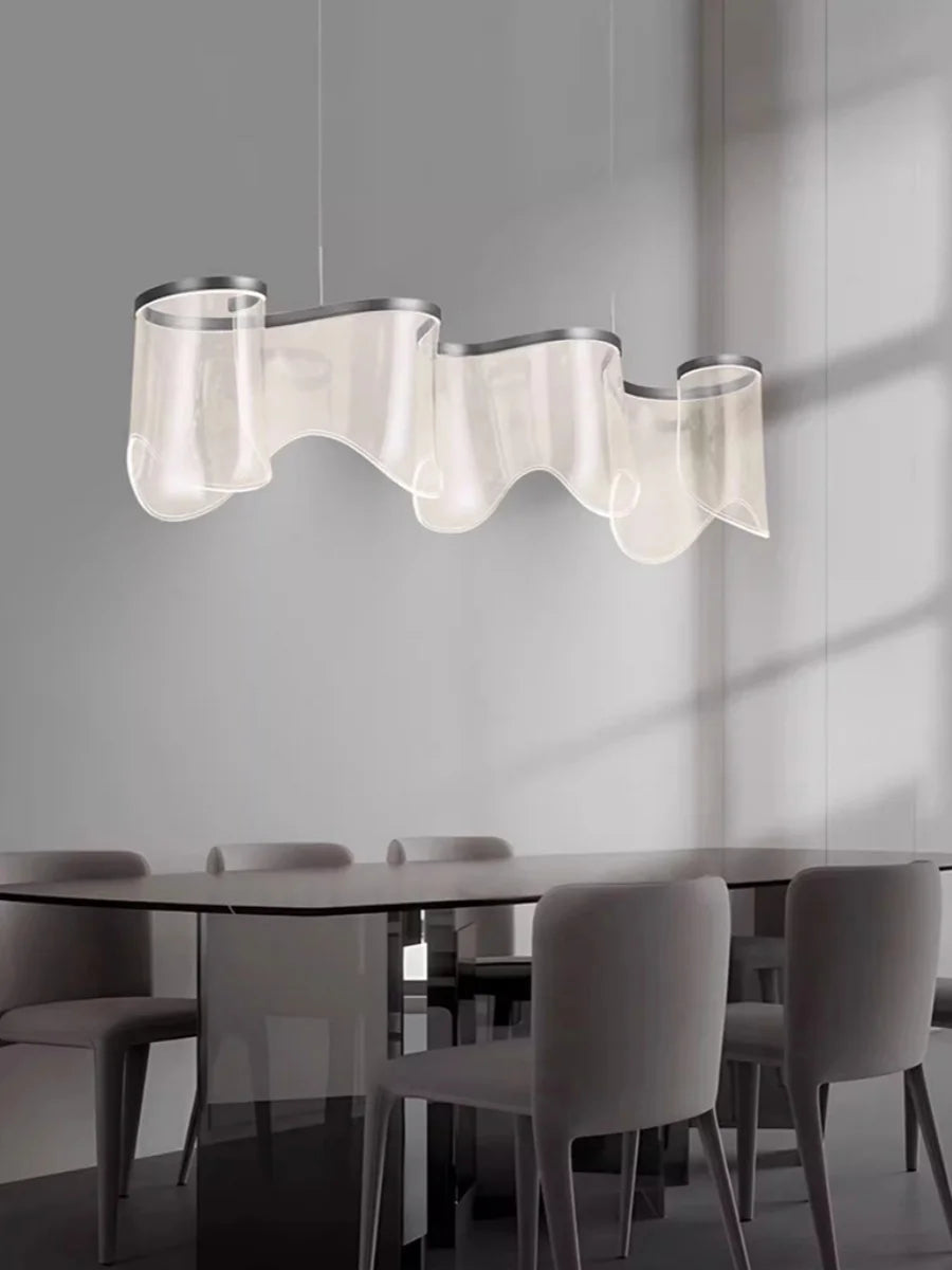 Modern dining room with a wavy pendant light fixture.